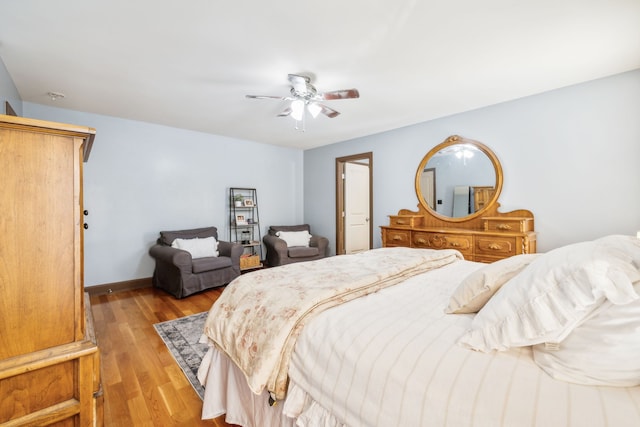 bedroom with light hardwood / wood-style flooring and ceiling fan