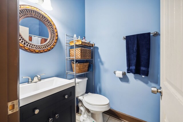 bathroom with vanity, toilet, and tile patterned floors