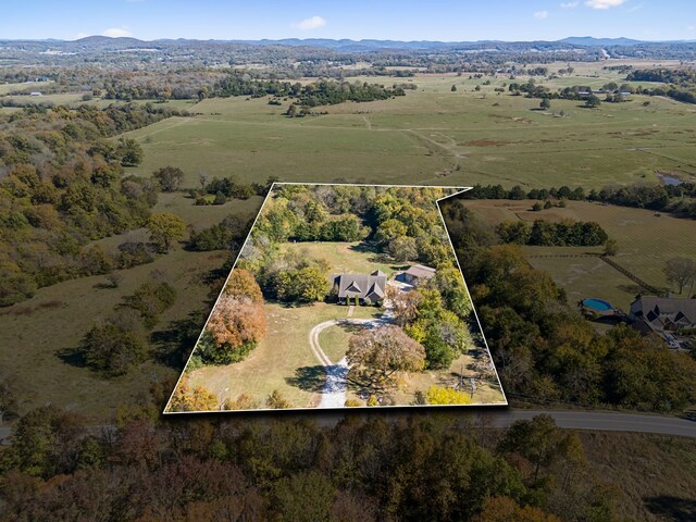 birds eye view of property featuring a mountain view and a rural view