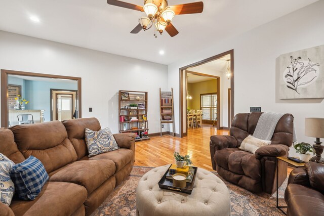 living room featuring hardwood / wood-style floors and ceiling fan