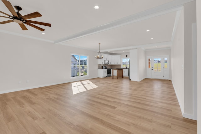 unfurnished living room featuring light wood-type flooring and plenty of natural light