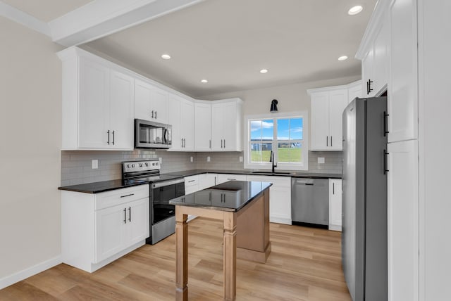 kitchen featuring white cabinetry, appliances with stainless steel finishes, and light wood-type flooring