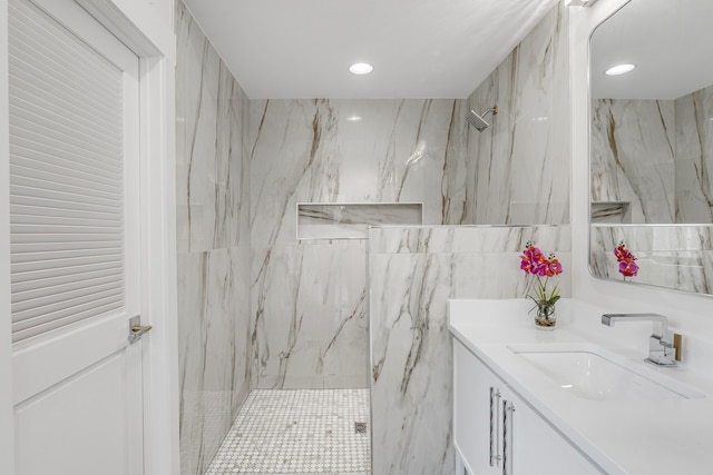 bathroom featuring a shower and vanity