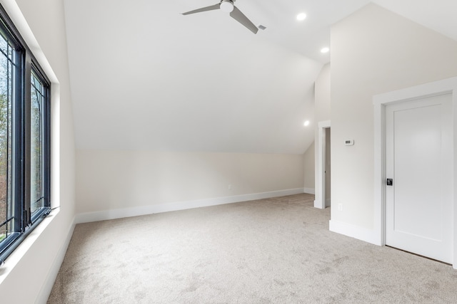 bonus room featuring ceiling fan, light colored carpet, and lofted ceiling