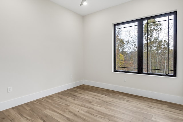 unfurnished room with light wood-type flooring