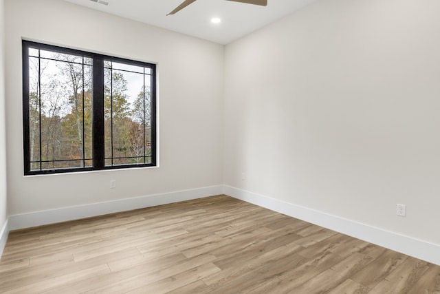 spare room featuring ceiling fan and light hardwood / wood-style floors