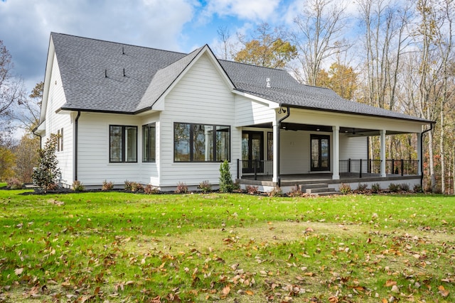 back of house featuring ceiling fan and a lawn