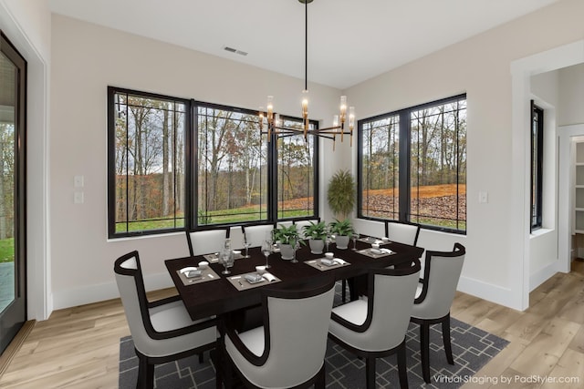 dining room featuring light hardwood / wood-style flooring and an inviting chandelier