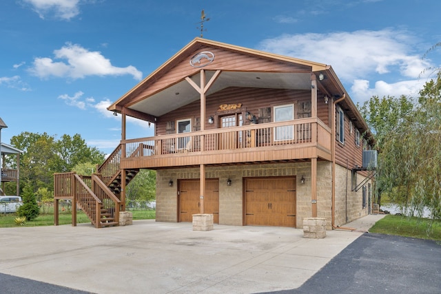 view of front of house with a deck, central AC, and a garage