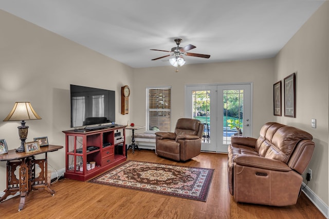 living room featuring hardwood / wood-style floors and ceiling fan