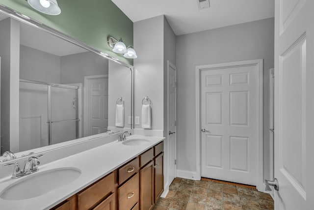 bathroom with vanity and a shower with door