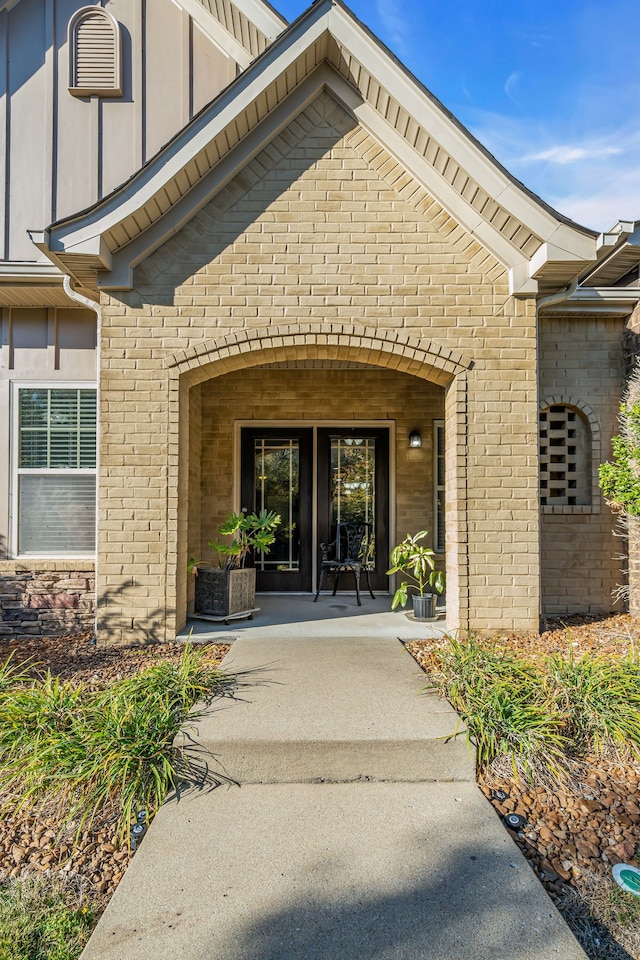 view of exterior entry featuring a patio area