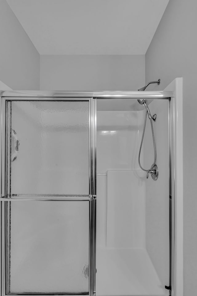 bathroom with a shower with shower door