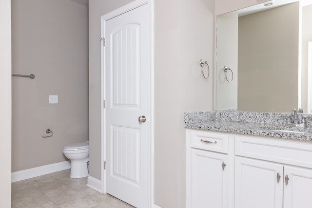 bathroom with vanity, toilet, and tile patterned flooring