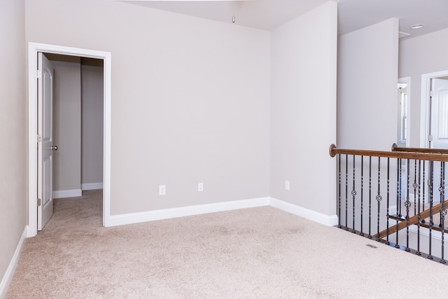 unfurnished room with light colored carpet