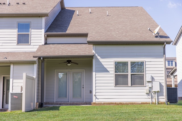 back of property featuring a lawn and ceiling fan