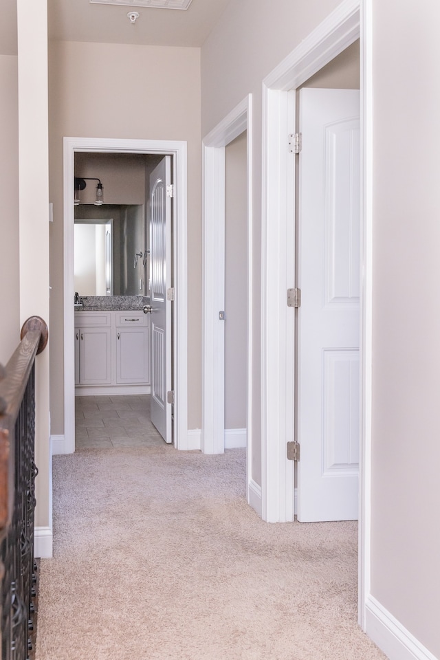 hall featuring light carpet