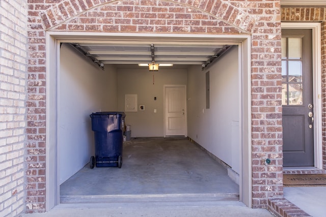 garage with a garage door opener and electric panel