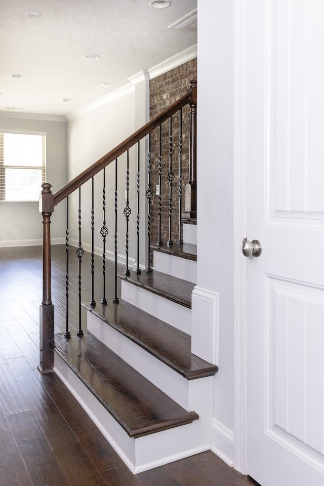 stairs with hardwood / wood-style flooring and ornamental molding