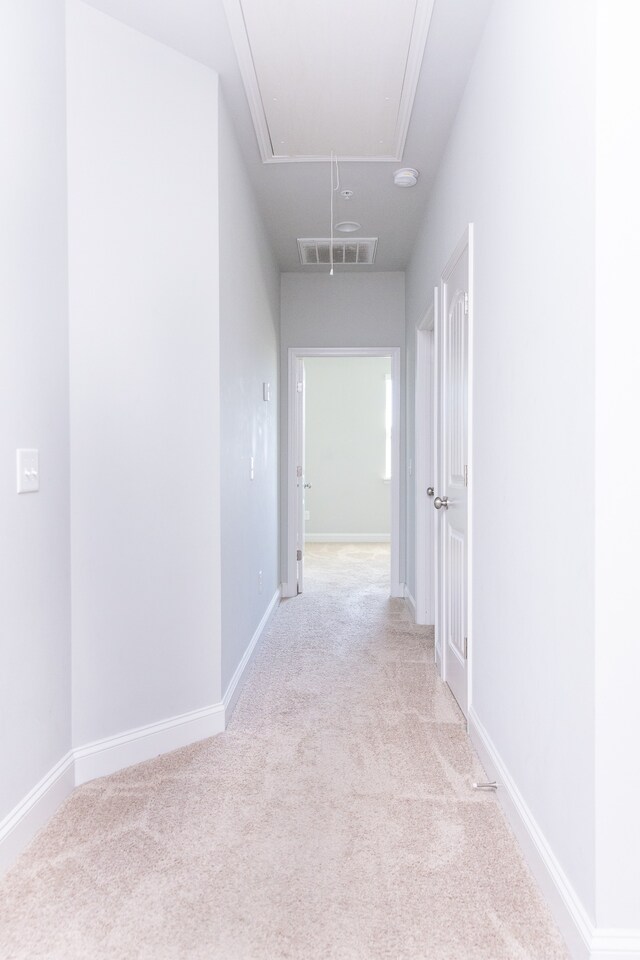 corridor featuring light colored carpet