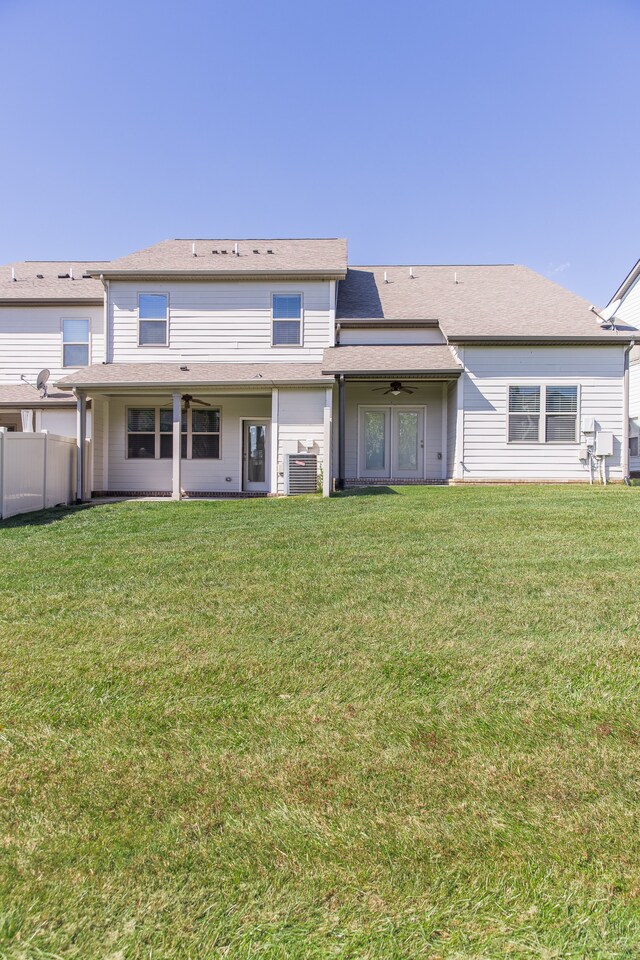 rear view of property with a lawn