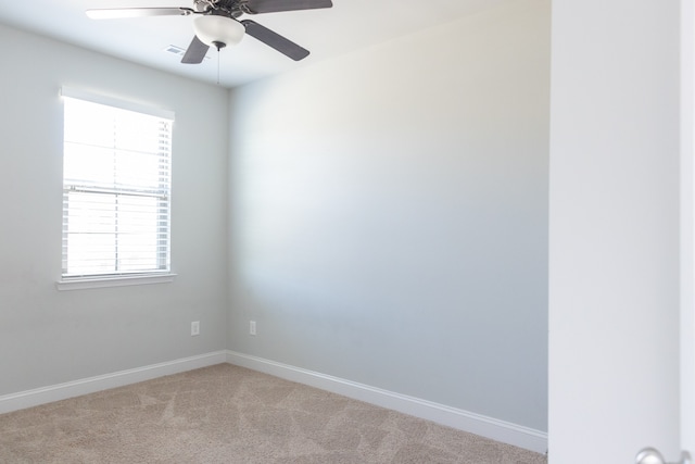 carpeted spare room with ceiling fan