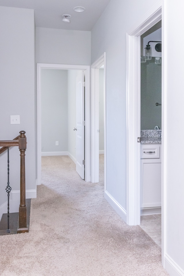 hall with light colored carpet