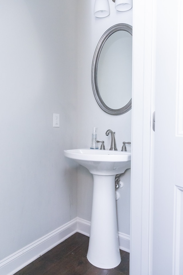 bathroom with hardwood / wood-style flooring and sink