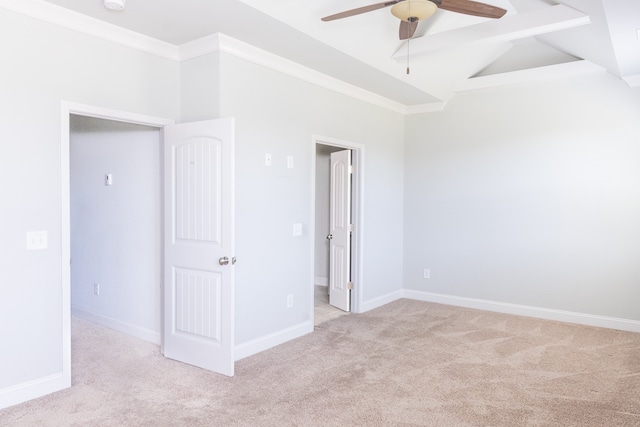 empty room with ceiling fan, vaulted ceiling with beams, and light colored carpet