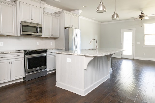 kitchen featuring dark wood-type flooring, a center island with sink, sink, light stone countertops, and appliances with stainless steel finishes