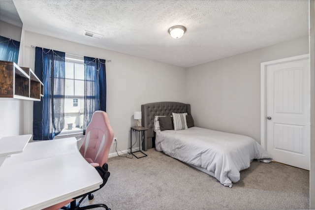 carpeted bedroom featuring a textured ceiling