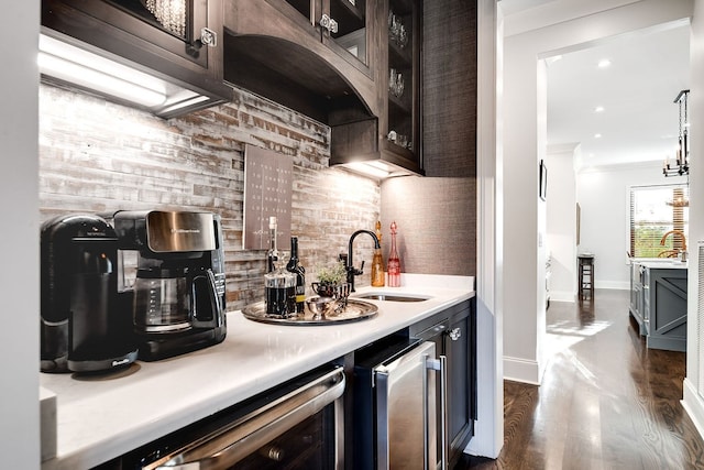 kitchen with wine cooler, stainless steel fridge, ornamental molding, dark hardwood / wood-style floors, and sink