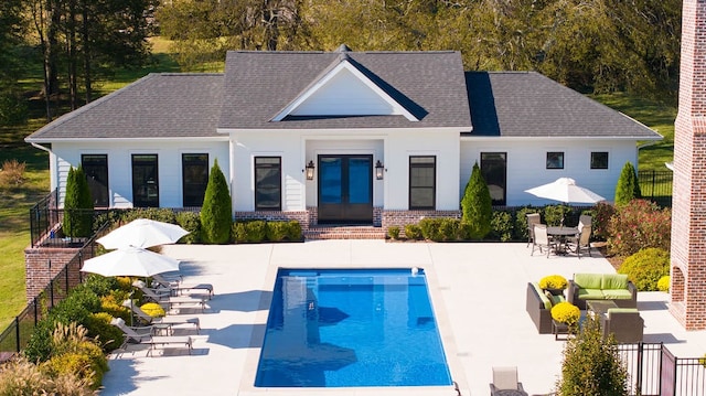 rear view of house featuring a patio and a fenced in pool