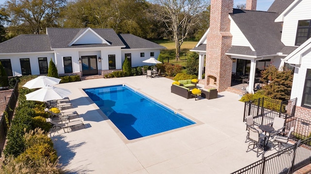 view of pool featuring outdoor lounge area and a patio