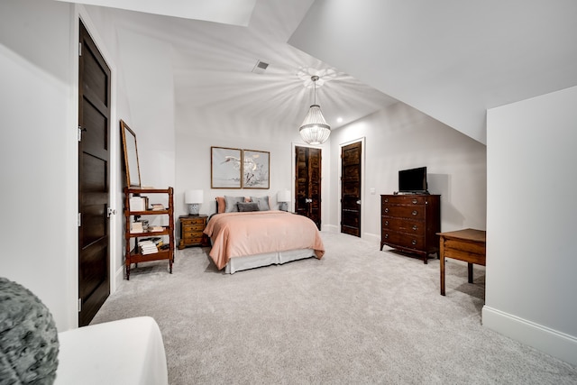 carpeted bedroom with a chandelier