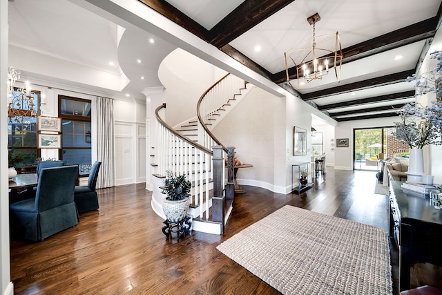 entrance foyer featuring beamed ceiling, dark wood-type flooring, and an inviting chandelier