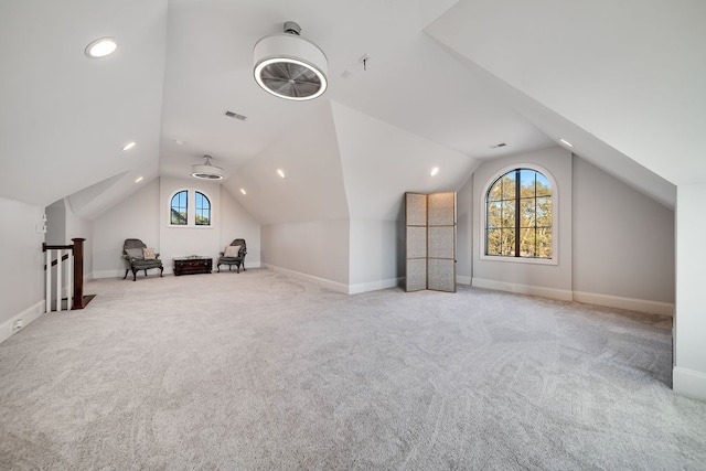 bonus room featuring lofted ceiling and light colored carpet