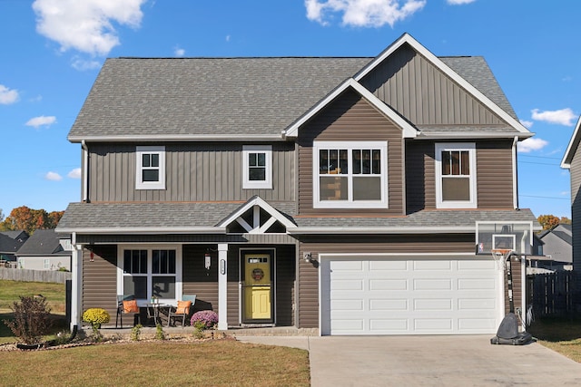 view of front of home featuring covered porch, a front lawn, and a garage