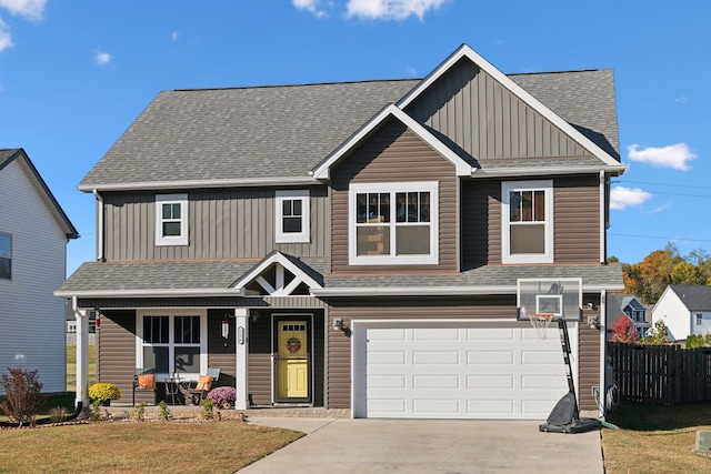 craftsman-style home featuring a front lawn, covered porch, and a garage