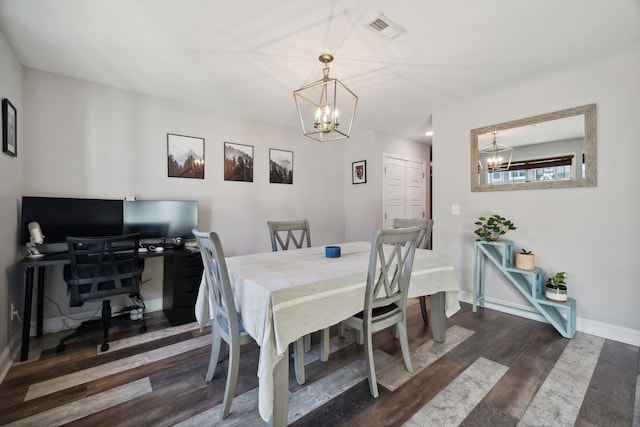 dining area with a notable chandelier and dark hardwood / wood-style flooring