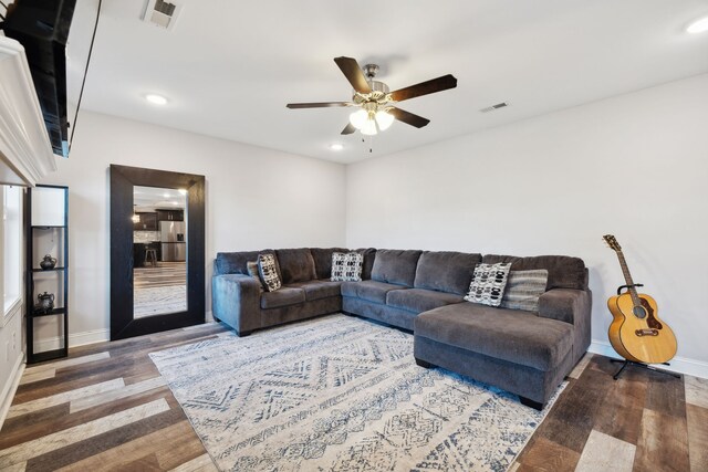 living room with wood-type flooring and ceiling fan