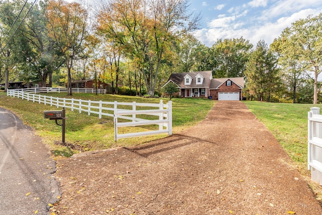 cape cod house with a front lawn, a garage, and a rural view