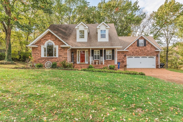 view of front of property featuring a front yard, a porch, and a garage