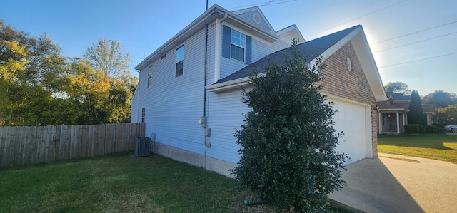 view of side of property featuring a yard and central air condition unit