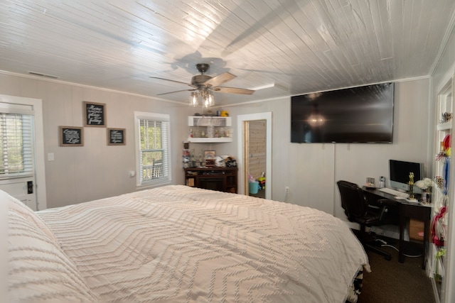 carpeted bedroom with crown molding and ceiling fan