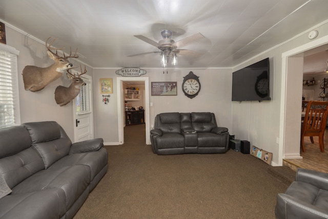 carpeted living room featuring plenty of natural light, ornamental molding, and ceiling fan