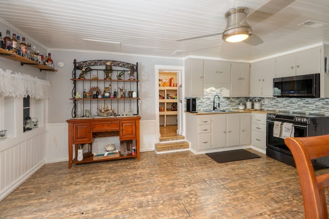 kitchen featuring backsplash, hardwood / wood-style floors, black / electric stove, crown molding, and ceiling fan