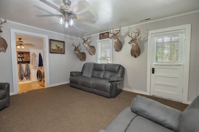 carpeted living room with crown molding and ceiling fan