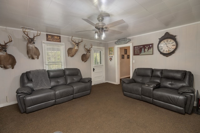 carpeted living room with ornamental molding and ceiling fan