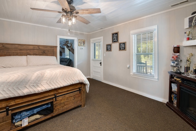 carpeted bedroom featuring ornamental molding and ceiling fan